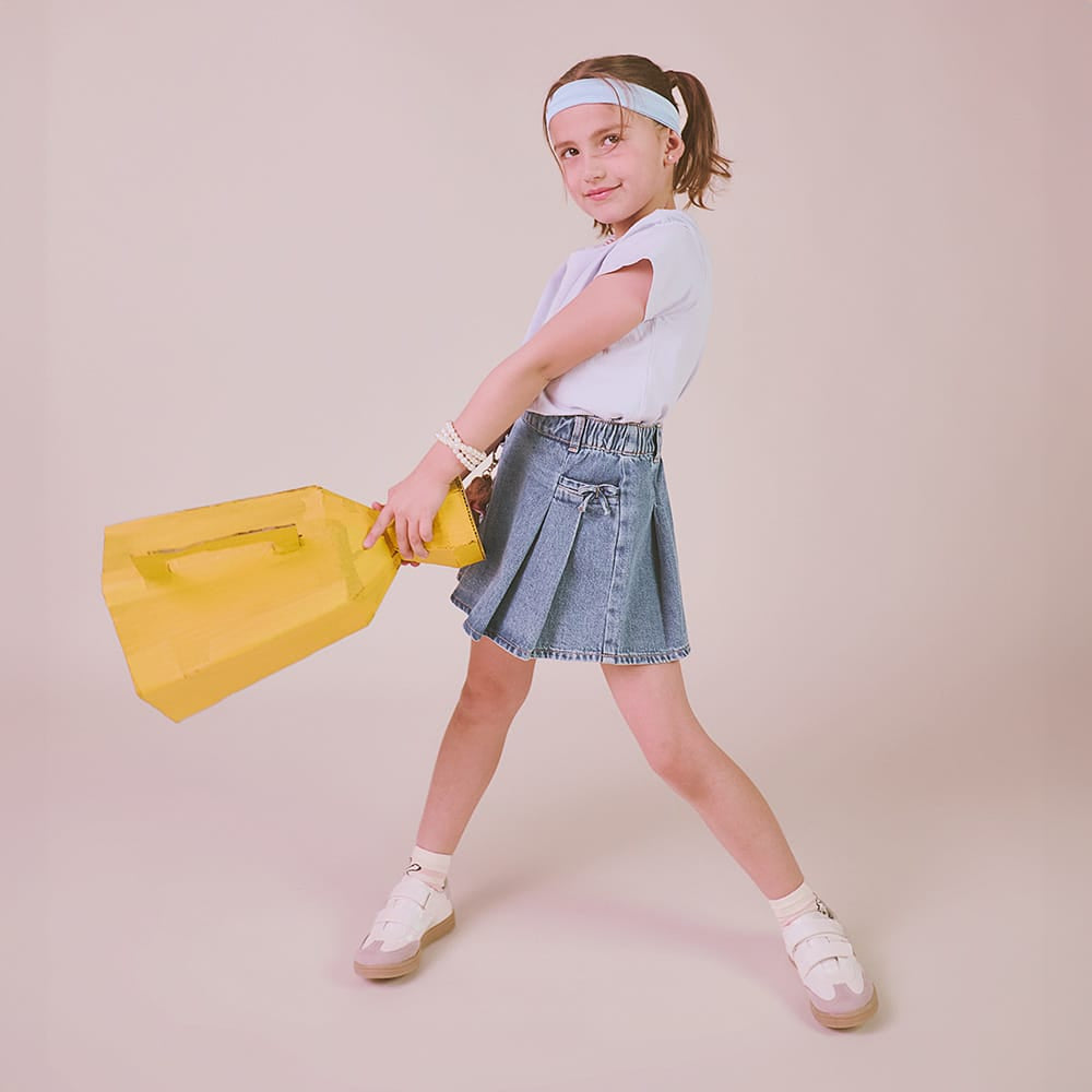 Niña usando tenis Coqueta y Audaz color blanco con detalles en plata, diseño cómodo y ligero ideal para uso diario.